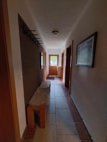 a hallway with a bench in a house at Ferienwohnung Haus Germania in Brixen im Thale