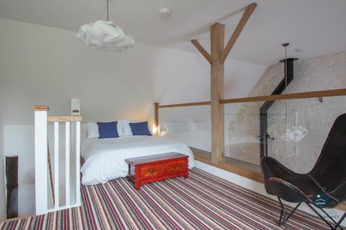 a bedroom with a bed and a desk and a chair at Stable Cottage at Poxwell Manor in Poxwell