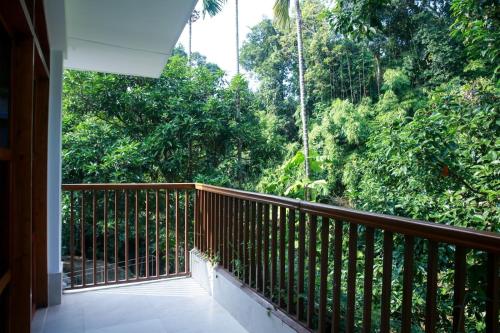 a balcony with a view of a forest at Balishira Resort Ltd. in Sreemangal