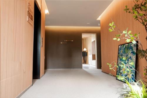a corridor of a building with a hallway at The Yard Boutique Hotel Shanghai 一隅酒店上海虹桥漕河泾店 in Shanghai