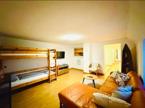 a living room with a couch and bunk beds at Ferienwohnung ESMA in Burgau