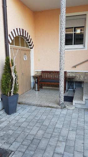 a wooden bench sitting outside of a building at Haus Lehneis in Teublitz
