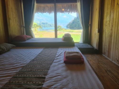 a room with a window with a teddy bear on the floor at Ba Be Retreat in Bak Kan