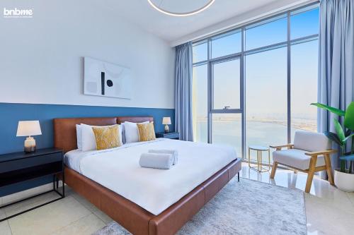 a bedroom with a large bed and a large window at bnbmehomes - Anwa in Dubai