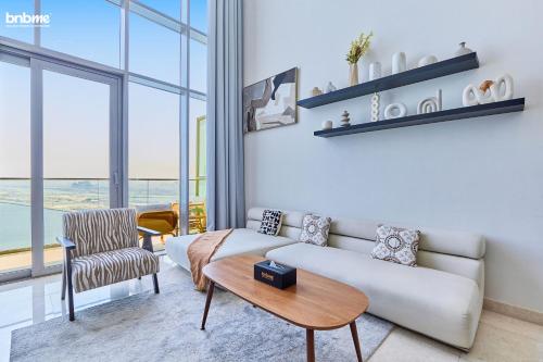 a living room with a couch and a table at bnbmehomes - Anwa in Dubai