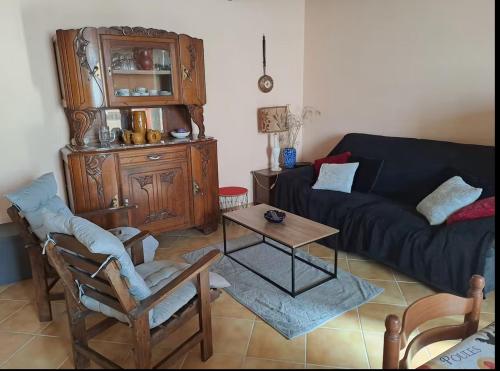 a living room with a couch and a table at Maison avec vue sur la campagne in Viersat