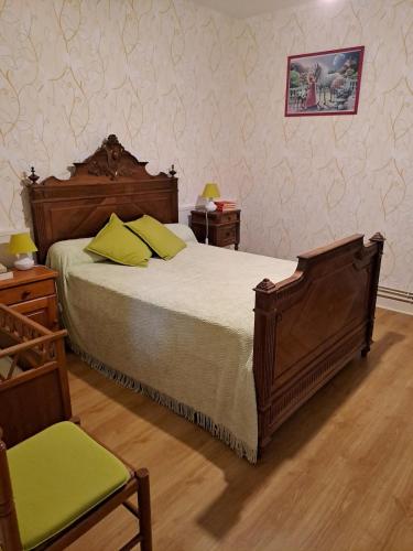 a bedroom with a bed and two tables and a chair at Maison avec vue sur la campagne in Viersat