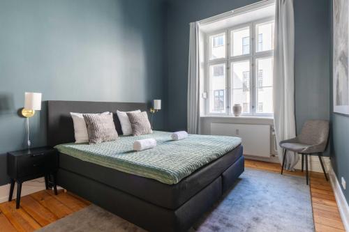 a bedroom with a bed and a window at Centrally Located 3 Bedroom Apartment in Copenhagen