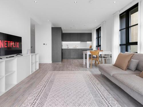 a living room with a couch and a table at Modern Flat in Central Cambridge in Girton