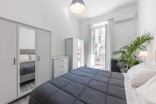 a bedroom with a large bed and a mirror at SUN HOUSE in Bari