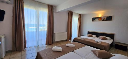Postel nebo postele na pokoji v ubytování Hotel Cosmos