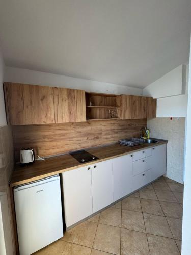 a kitchen with white cabinets and a counter top at Apartmani Cupic in Budva
