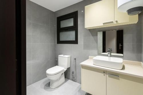 a bathroom with a white toilet and a sink at Beachfront Bliss Awaits You at Porto Said in Port Said