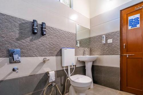 a bathroom with a toilet and a sink at WOW STAYZ2 Pachmarhi Foothill Cottages in Pachmarhī