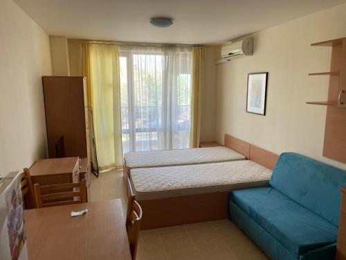 a room with a bed and a couch and a window at Julia Vigo Panorama apartments in Nesebar