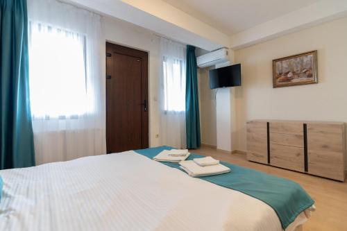 a bedroom with a bed with two towels on it at Konaci Manastir Sveti Stefan - Ohrid in Ohrid