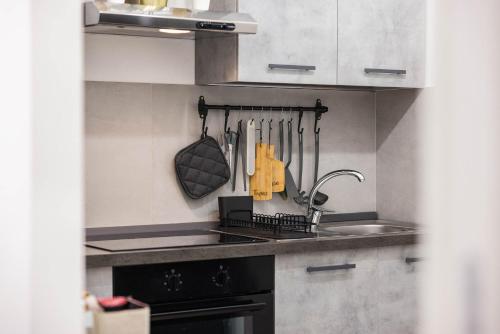 a kitchen with a sink and a stove top oven at SUN HOUSE in Bari