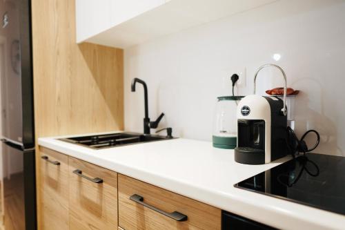 a kitchen with a counter top with a coffee maker at Luxury Apartment at Saranda Port in Sarandë