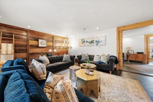 a living room with a blue couch and tables at Green Acres Retreat in Hancock