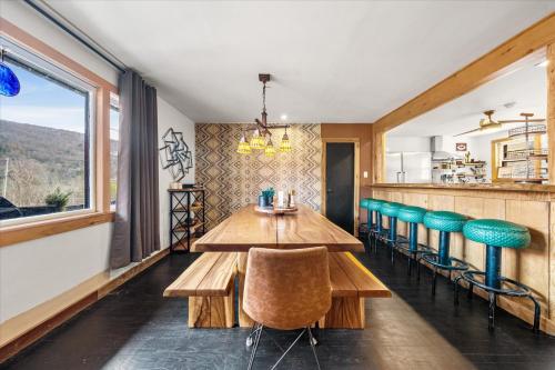 a dining room with a wooden table and chairs at Green Acres Retreat in Hancock