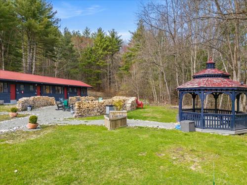a gazebo in a yard next to a building at Green Acres Retreat in Hancock