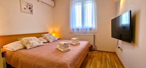 a bedroom with a bed with two towels on it at Villa Ana with a private pool on a 3000m2 property in Čvrljevo