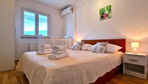 a bedroom with a bed with towels on it at Villa Ana with a private pool on a 3000m2 property in Čvrljevo