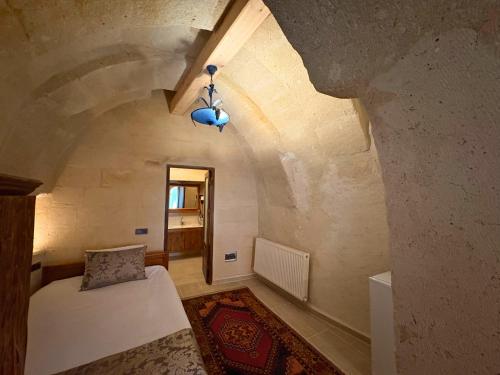 a bedroom with a bed in a room with an attic at Elysee Cave House in Goreme
