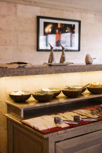 a counter with bowls and spoons on top at Heybe Hotel & Spa in Goreme