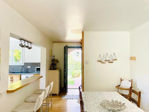 une cuisine et une salle à manger avec une table dans l'établissement La Maison d'Apolline, à Sahune