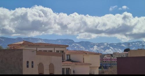 a group of buildings with mountains in the background at Maison Halimos in Midelt