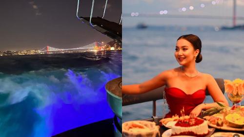 Una donna con un vestito rosso seduta a un tavolo con del cibo di Nova Yachting a Istanbul