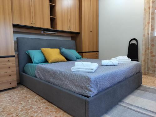 a bedroom with a bed with towels on it at Cozy Apartments in Lido di Ostia