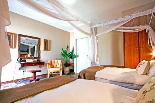 En eller flere senge i et værelse på Auob Country Lodge