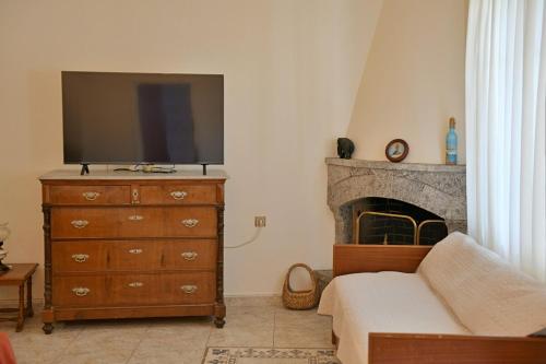 a living room with a tv on top of a dresser at Astraea 7 in Hydra