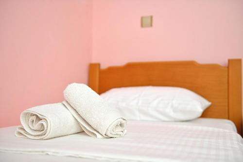 a bed with two towels on top of it at Astraea 7 in Hydra