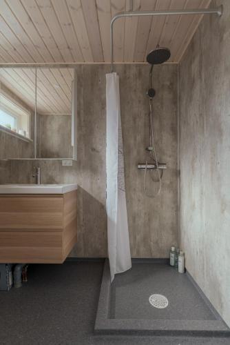 a bathroom with a shower and a sink at 2BR House with Scenic Views - Parking - Klaksvík in Klaksvík