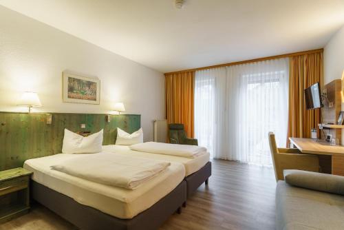 Postel nebo postele na pokoji v ubytování Stadthotel Pfeffermühle