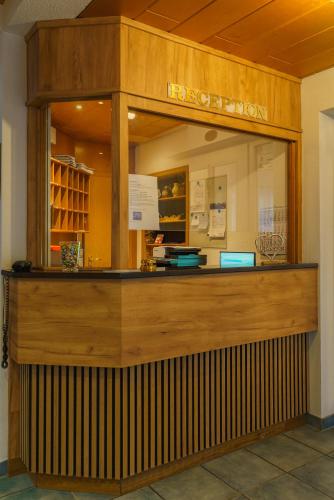 a restaurant with a counter in a building at Stadthotel Pfeffermühle in Gengenbach