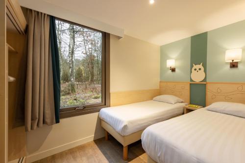 Ένα ή περισσότερα κρεβάτια σε δωμάτιο στο Center Parcs Les Hauts de Bruyères