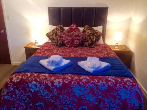a bed with two towels and pillows on it at Metro Star in London