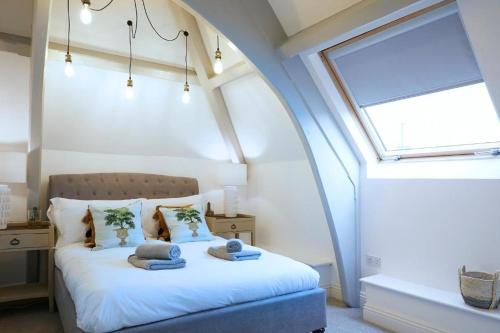 a bedroom with a bed with towels on it at Modern Comfort in a Beautiful Location - No3 Rosedene Mews in Marske-by-the-Sea