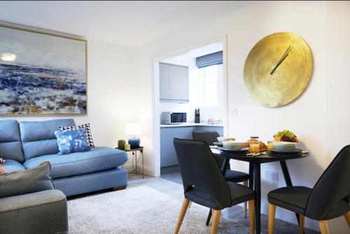 a living room with a table and a blue couch at Modern Comfort in a Beautiful Location - No3 Rosedene Mews in Marske-by-the-Sea