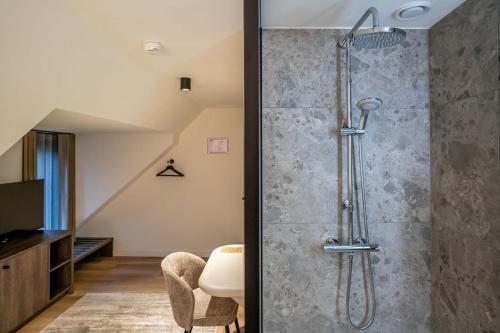 a shower with a glass door in a bathroom at Boutique Hotel Annamaes, Maastricht-Hoge Kempen in Lanaken