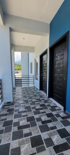 a hallway with two doors and a tile floor at Monaco Aparments in La Ceiba