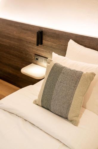 a bed with a pillow sitting on top of it at Boutique Hotel Annamaes, Maastricht-Hoge Kempen in Lanaken