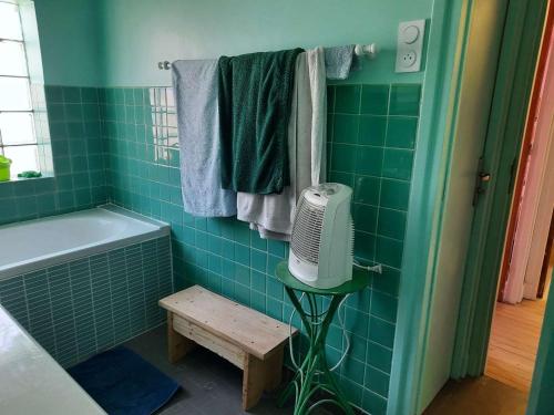 a bathroom with a green tiled tub and a fan at Maison familiale rénovée pour 13 pers. à Royan, proche plage - FR-1-494-204 in Royan