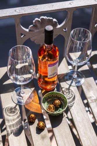 a bottle of whiskey sitting on a table with two wine glasses at SUN HOUSE in Bari