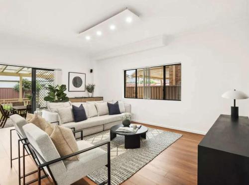 a living room with a couch and a table at Luxury house hotel Lidcombe Sydeny Australia in Rookwood Station
