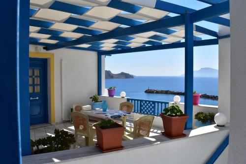 a view of the ocean from the balcony of a house at Arhontiko Hotel in Foinikion